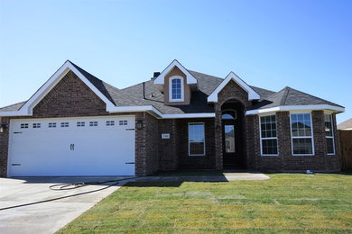 Traditional brown one-story brick gable roof idea in Austin