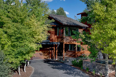 Trendy brown two-story wood exterior home photo in Other