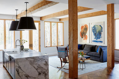 Inspiration for a mid-sized french country open concept medium tone wood floor, brown floor and exposed beam living room remodel in Toronto with white walls and no tv
