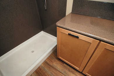 Alcove shower - mid-sized 3/4 brown floor alcove shower idea in Albuquerque with shaker cabinets, medium tone wood cabinets, a one-piece toilet and solid surface countertops