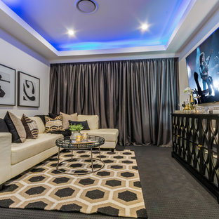 Cette image montre une salle de cinéma design fermée avec un mur blanc, moquette, un téléviseur fixé au mur et un sol gris.