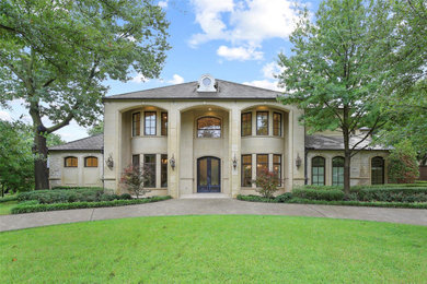 Example of a french country home design design in Dallas