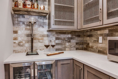 Inspiration for a mid-sized cottage l-shaped vinyl floor and brown floor enclosed kitchen remodel in Chicago with shaker cabinets, gray cabinets, quartz countertops, beige backsplash, subway tile backsplash, stainless steel appliances and white countertops