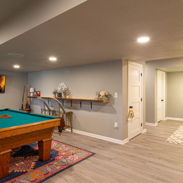 Basement Utilizing Open Space to Shoot Pool and Watch Favorite Sports Team