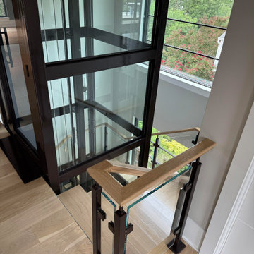Project #136 | Modern Floating Staircase Encircling Glass Elevator