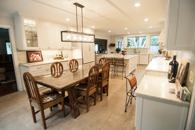 Huge transitional u-shaped porcelain tile and beige floor kitchen pantry photo in Austin with an undermount sink, beaded inset cabinets, white cabinets, quartzite countertops, green backsplash, glass tile backsplash, paneled appliances, an island and white countertops