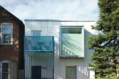 Inspiration for a small contemporary white two-story concrete fiberboard exterior home remodel in Toronto