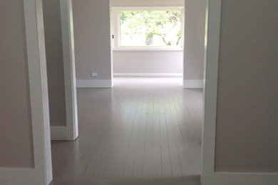 Design ideas for a traditional living room in Wollongong with painted wood floors.