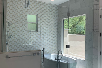Bathroom - large mediterranean master white tile and marble tile porcelain tile, white floor and double-sink bathroom idea in Phoenix with raised-panel cabinets, white cabinets, a one-piece toilet, white walls, an undermount sink, granite countertops, a hinged shower door, white countertops and a built-in vanity