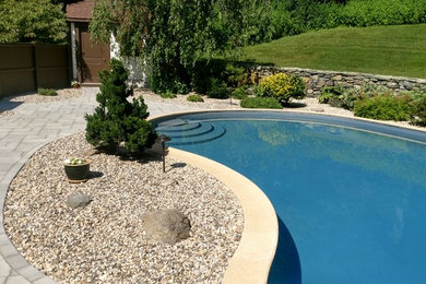 This is an example of a mid-sized full sun backyard concrete paver landscaping.
