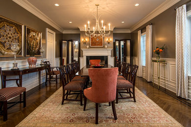 Inspiration for a traditional dining room in New York with grey walls, medium hardwood floors and a standard fireplace.