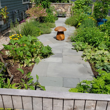 An extensive landscape project with stonewalls, patio, dry river bed & more