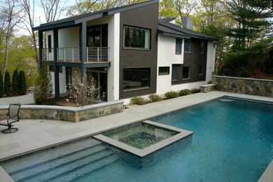 Example of a large minimalist backyard rectangular hot tub design in New York