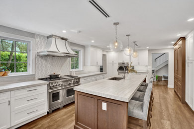 Inspiration for a transitional eat-in kitchen remodel with shaker cabinets, white cabinets, white backsplash, an island, white countertops and quartzite countertops