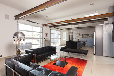 Example of an urban open concept concrete floor living room design in Albuquerque with white walls
