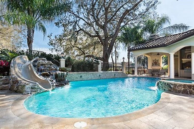 Example of an arts and crafts pool design in Tampa