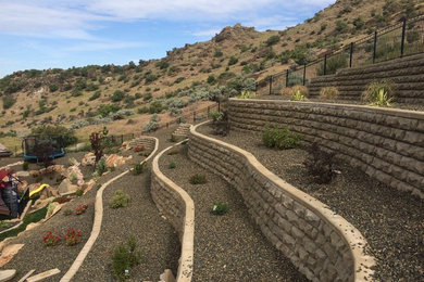 Design ideas for a large southwestern full sun hillside retaining wall landscape in Boise.