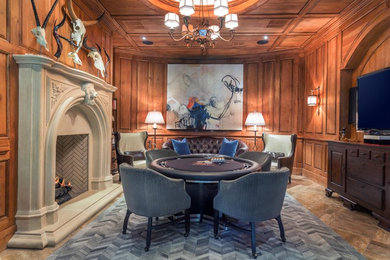 Inspiration for a mid-sized arts and crafts basement in Atlanta with a game room, a standard fireplace, brown walls, travertine floors and a stone fireplace surround.