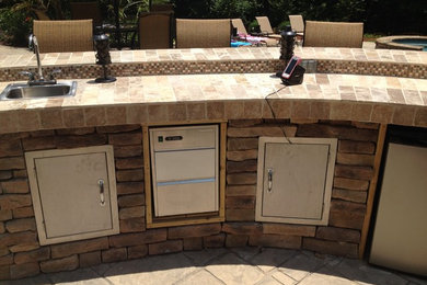 Inspiration for a mid-sized timeless backyard stamped concrete patio kitchen remodel in Atlanta with no cover