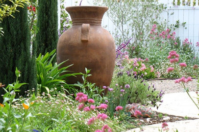 Design ideas for a mid-sized shabby-chic style full sun backyard gravel garden path in San Diego.