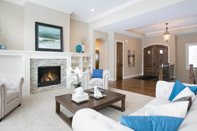 Photo of a large formal open concept living room in Minneapolis with carpet, a standard fireplace and a stone fireplace surround.