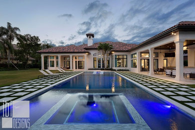 Large trendy backyard stone and rectangular hot tub photo in Miami