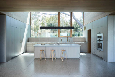 Example of a minimalist kitchen design in San Francisco with an island