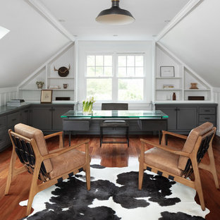 Example of a cottage freestanding desk dark wood floor and brown floor study room design in Boston with white walls and no fireplace