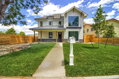 Example of a large cottage white three-story concrete fiberboard and board and batten exterior home design in Denver with a shingle roof and a gray roof