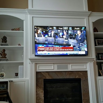 Novi, TV over fireplace with all cabling concealed.