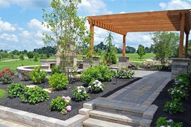 Large traditional backyard partial sun formal garden in Columbus with a fire feature and brick pavers.