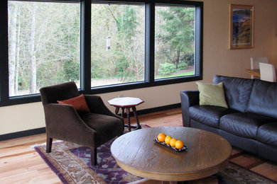 Inspiration for a contemporary open concept living room in Seattle with red walls, light hardwood floors, a standard fireplace, a concrete fireplace surround, no tv and beige floor.