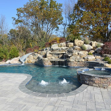 Custom Freeform style salt water in ground pool with Waterslide and Spa
