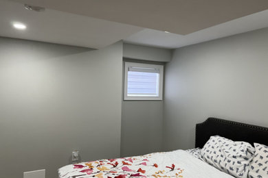Bedroom - mid-sized contemporary guest vinyl floor and beige floor bedroom idea in Toronto with gray walls
