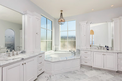 Mid-sized transitional master white tile and stone tile corner bathtub photo in Phoenix with beaded inset cabinets, white cabinets, marble countertops, gray walls and an undermount sink