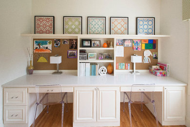 Large elegant built-in desk light wood floor study room photo in Minneapolis with white walls