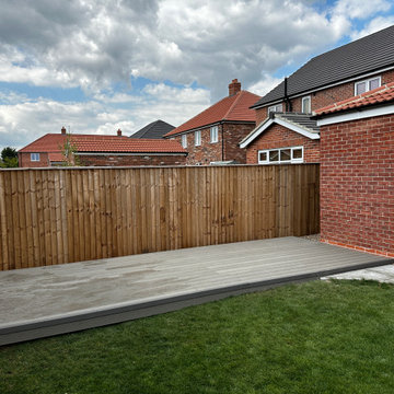 Low Composite Deck Between a Fence and New Lawn