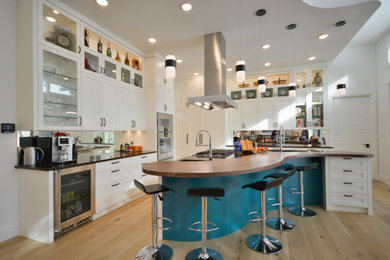 Example of a large transitional l-shaped open concept kitchen design in Toronto with shaker cabinets, white cabinets and an island