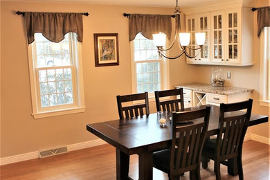 Dining room - small traditional medium tone wood floor and brown floor dining room idea in Phoenix with brown walls