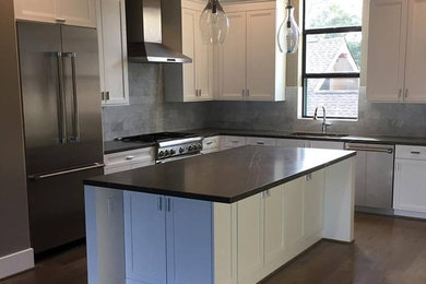 Inspiration for a mid-sized modern l-shaped light wood floor eat-in kitchen remodel in Houston with an undermount sink, beaded inset cabinets, white cabinets, marble countertops, gray backsplash, stone tile backsplash, stainless steel appliances and two islands
