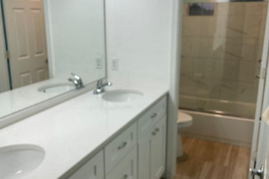 Mid-sized transitional kids' white tile and porcelain tile ceramic tile, beige floor and double-sink bathroom photo in Phoenix with shaker cabinets, white cabinets, white walls, an undermount sink, quartz countertops, white countertops and a built-in vanity