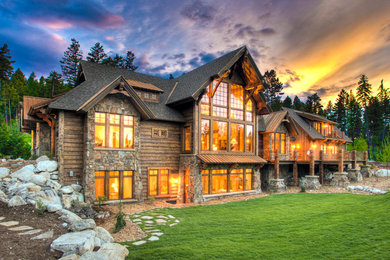 Inspiration for a huge rustic brown two-story wood house exterior remodel in Other