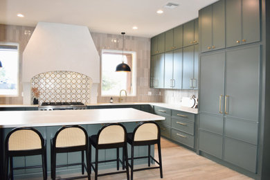 Large transitional porcelain tile and brown floor eat-in kitchen photo in Phoenix with an undermount sink, shaker cabinets, green cabinets, gray backsplash, ceramic backsplash, paneled appliances, an island and white countertops