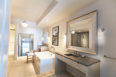 Mid-sized minimalist master light wood floor bathroom photo in Miami with flat-panel cabinets, light wood cabinets, a wall-mount toilet, gray walls, an integrated sink and concrete countertops
