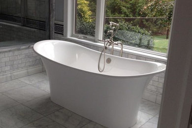 Large gray tile marble floor bathroom photo in Other with gray cabinets and gray walls