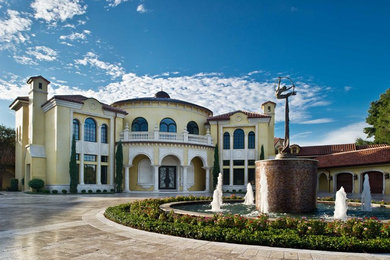 Mediterranean yellow exterior home idea in Orlando