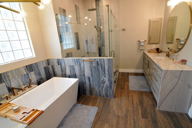 Inspiration for a large eclectic master blue tile and porcelain tile porcelain tile, brown floor and double-sink bathroom remodel in Other with shaker cabinets, gray cabinets, a two-piece toilet, gray walls, an undermount sink, quartzite countertops, a hinged shower door and a built-in vanity