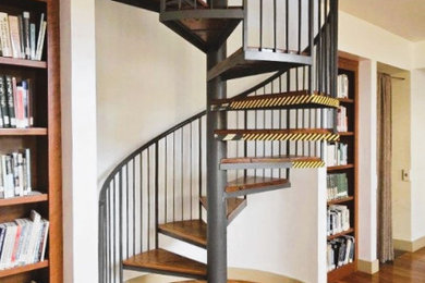 Small mountain style wooden spiral open and metal railing staircase photo in Detroit