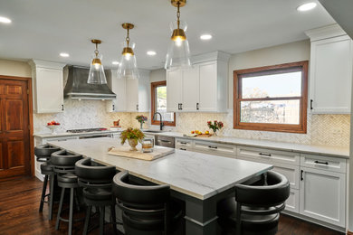 Design ideas for a mid-sized transitional l-shaped eat-in kitchen in Chicago with an undermount sink, flat-panel cabinets, white cabinets, quartzite benchtops, white splashback, marble splashback, stainless steel appliances, dark hardwood floors, with island, brown floor and white benchtop.