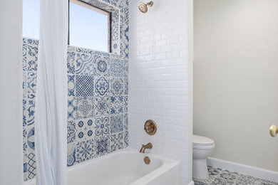 Mid-sized elegant kids' blue tile and ceramic tile ceramic tile, blue floor and single-sink bathroom photo in Houston with raised-panel cabinets, white cabinets, a two-piece toilet, beige walls, an undermount sink, quartz countertops, white countertops and a built-in vanity